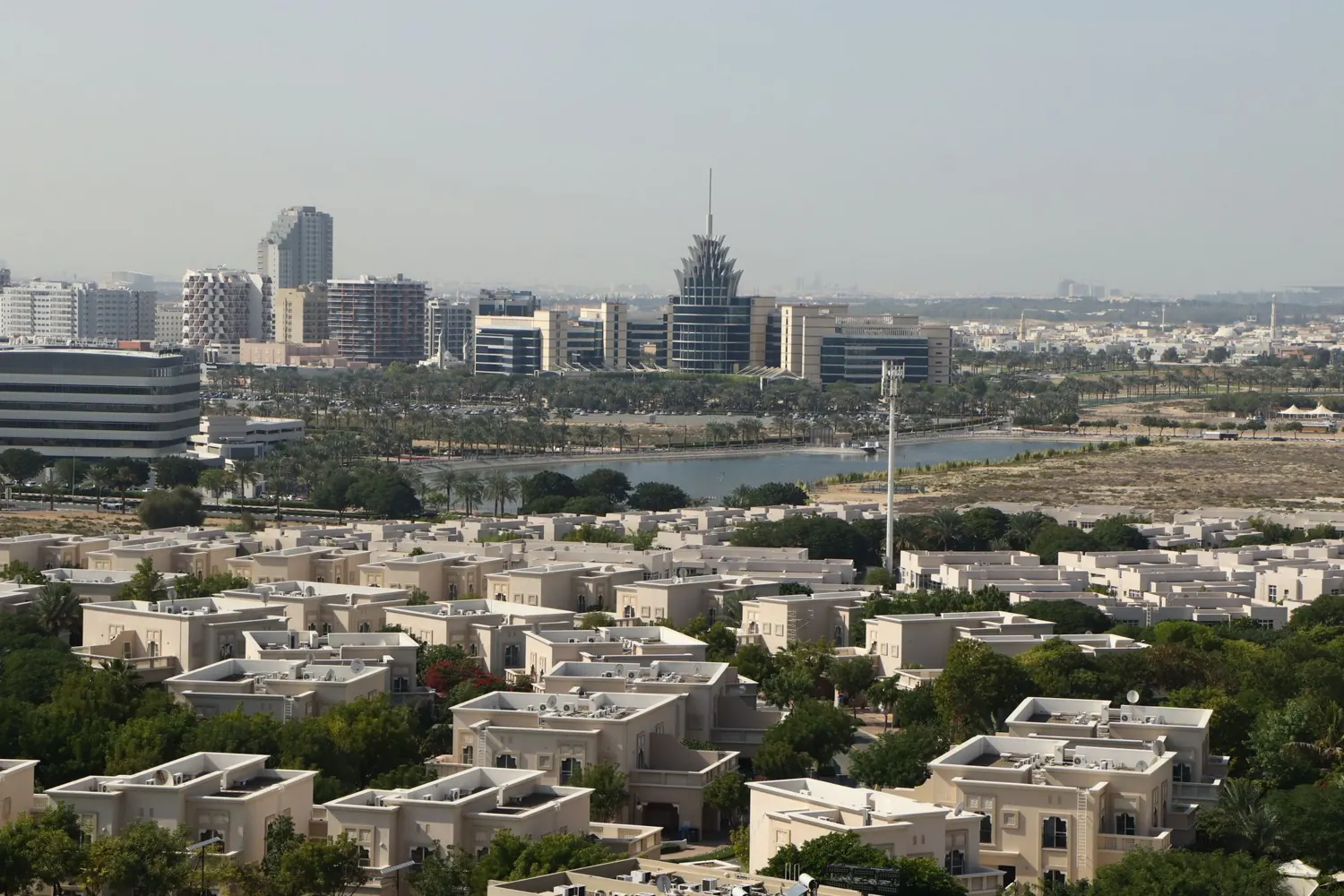 Villas and greenery of Dubai Silicon Oasis with the district skyline beyond