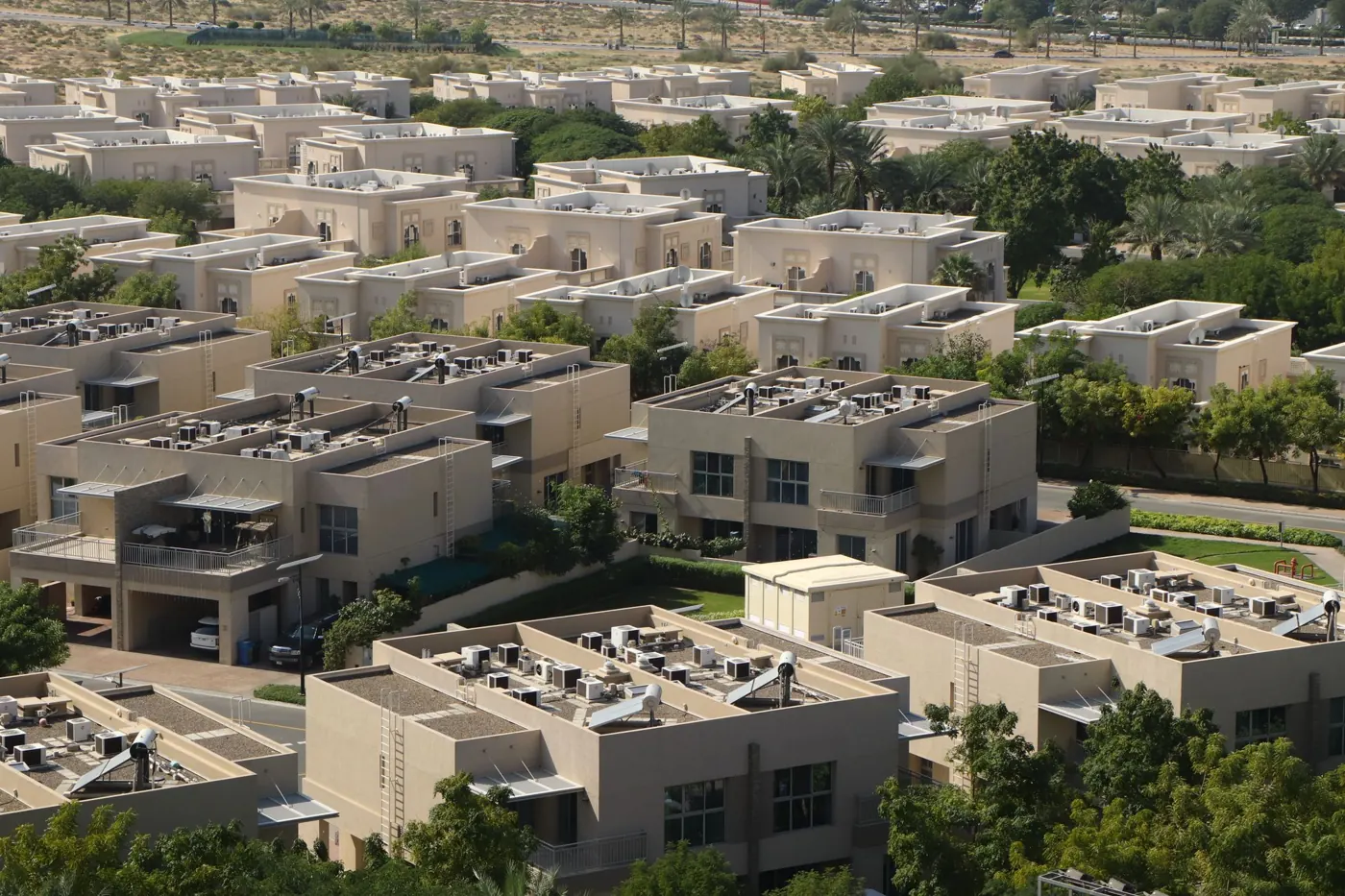 Sand-toned townhouses among gardens in Dubai Silicon Oasis